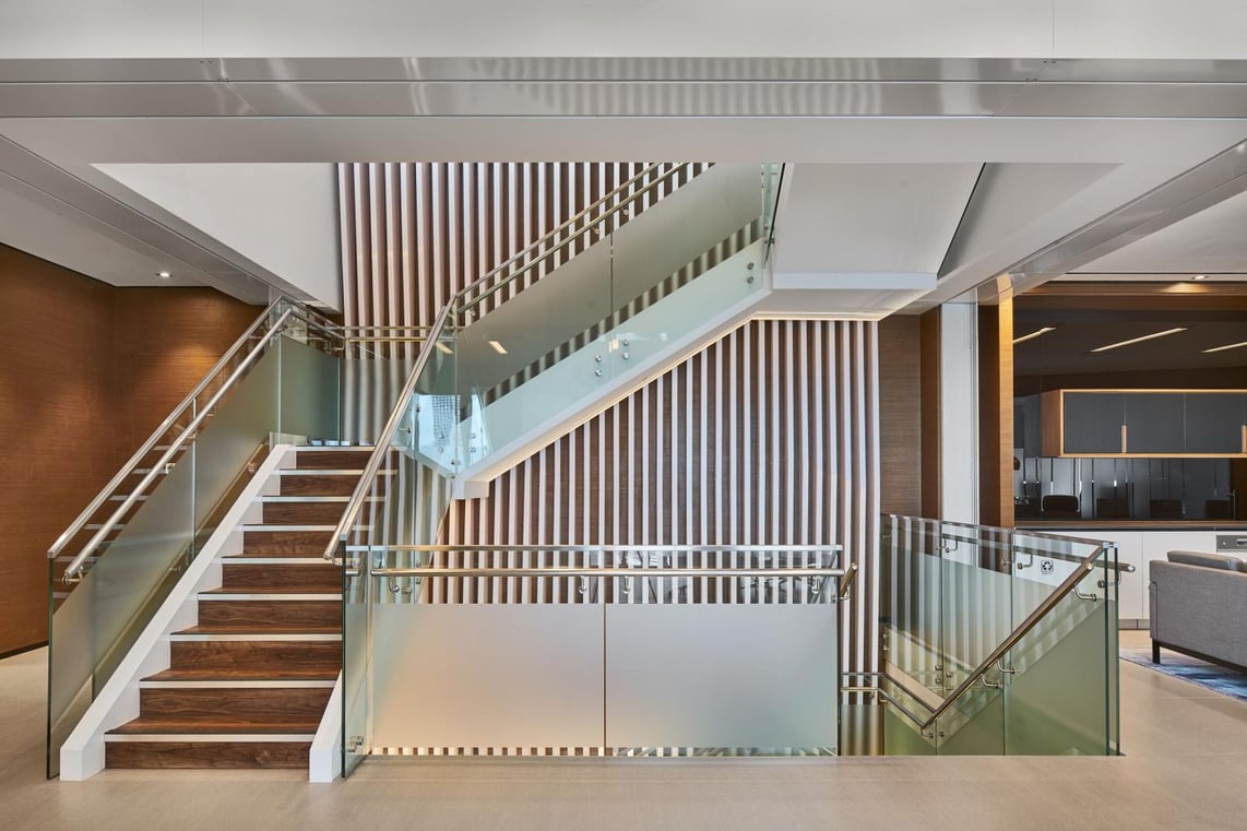 Beautiful internal staircase made of wood, glass and metal.